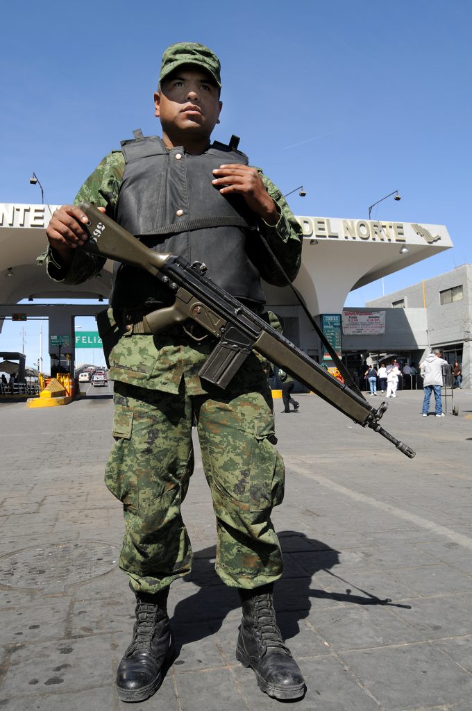 CIUDAD JUAREZ, MEXICO - FEB 27: An army soldier checks vehicles traveling from Mexico to the U.S. on February 27, 2009, on a checkpoint in Ciudad Juarez, Mexico.
