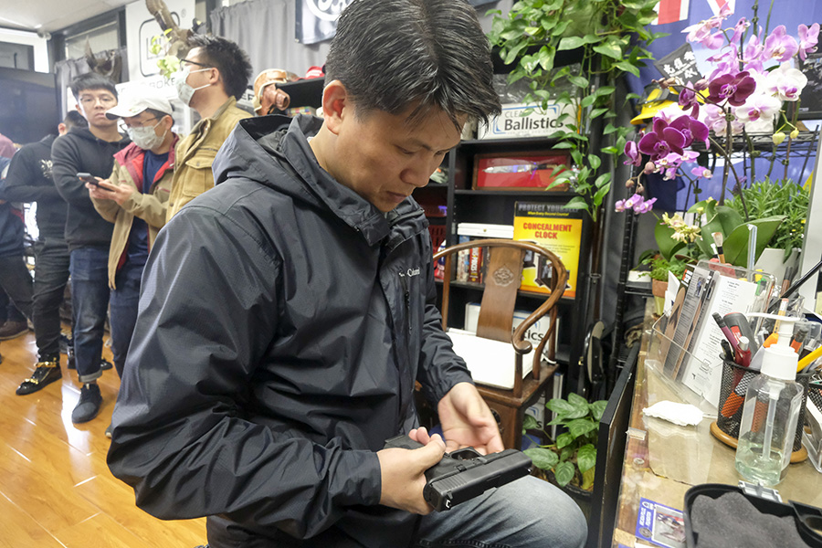 asian man gun store GLOCK pistol