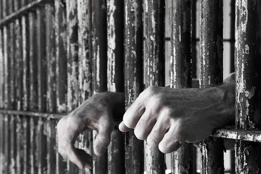 jail cell bars hands