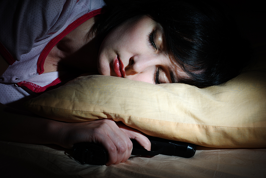 Women Sleeps With The Gun Under The Pillow