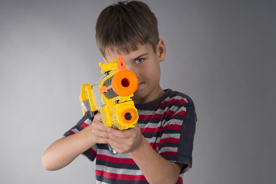 kid boy with toy gun