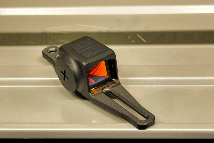 A Vortex Viper Shotgun red dot on a metal table, not mounted to a gun. 