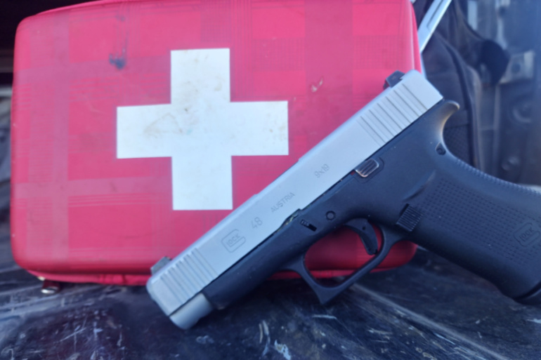 gun and first aid kit