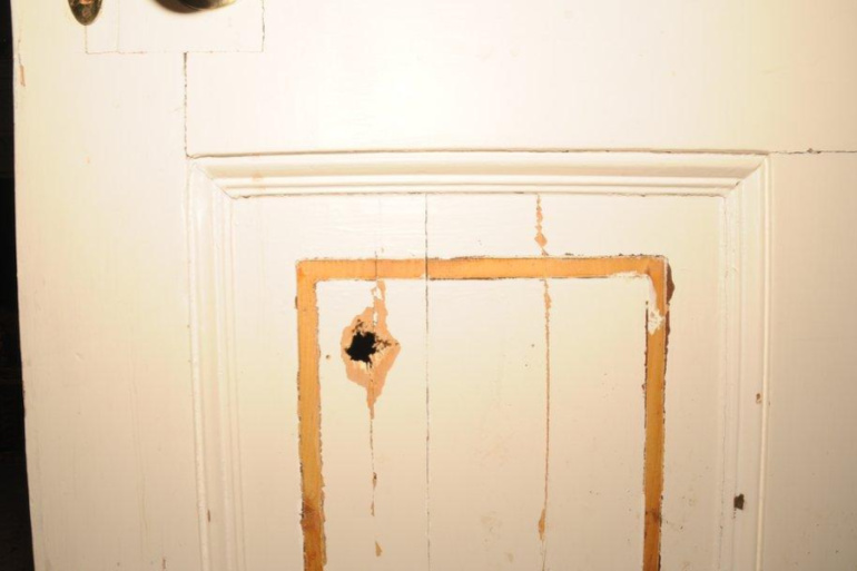 door with bullet hole